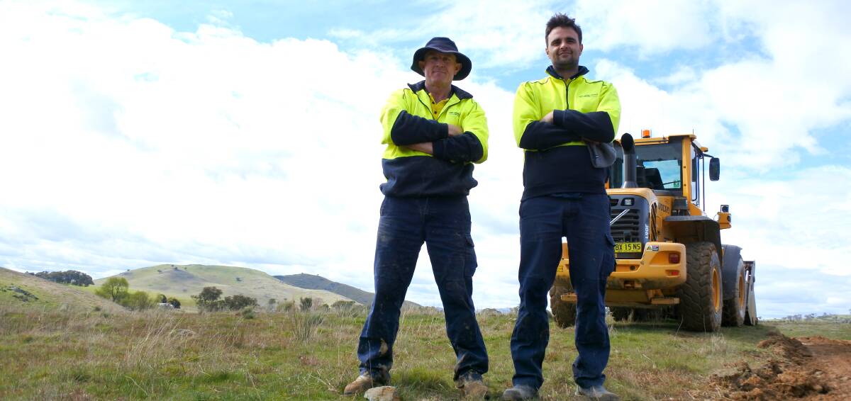 Dirty occupation: Yass Valley Council workers David Halley and Rudi Mihaljevic hard at work grading Ledgers Creek Road. Photo:  Jessica Cole. 