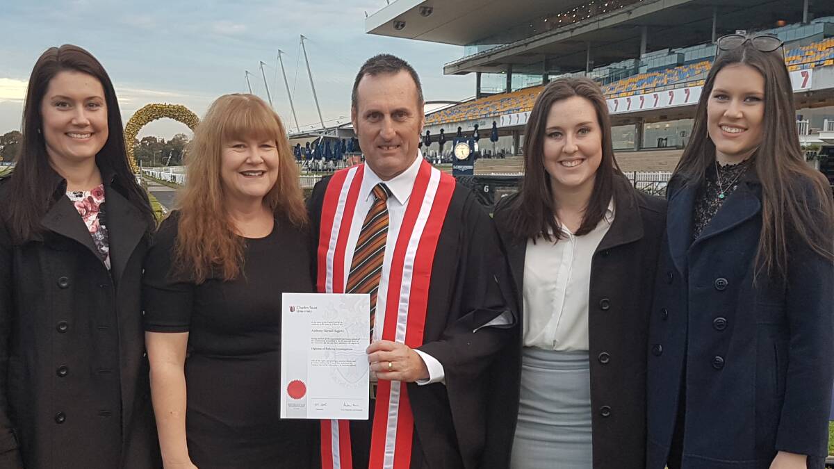 Proud family: Elizabeth, Rhonda, Tony, Erin and Emma, stand proudly together at Tony's graduation at Rosehill Racecourse in Sydney. Photo: Supplied. 