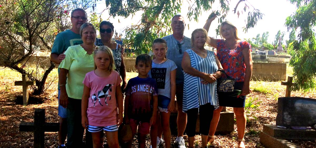 Proudly Ngunnawal: Three generations of Aboriginal community stand among the remains of their ancestors, recently declared an Aboriginal place. Photo: Jessica Cole. 