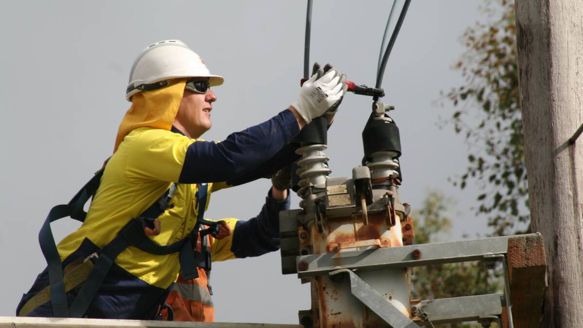 Power outages: Crews working to fix a damaged powerline after severe weather. Photo: Supplied. 