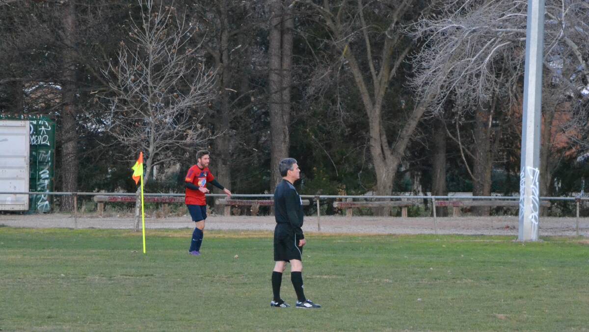 It's a lonely life: the referee watches the action during the Yass Redbacks game on the weekend, with his whistle at the ready.