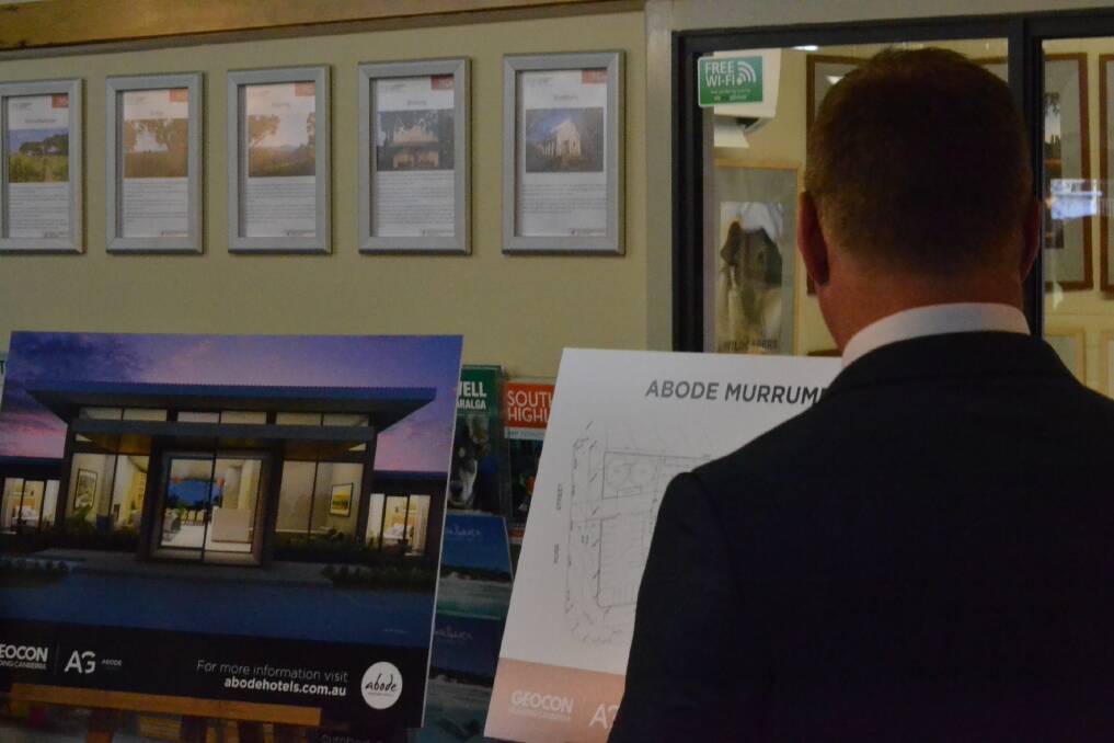 Mr Donkin with the plans for the hotel layout and artist's rendering. Photo: Zac Lowe. 