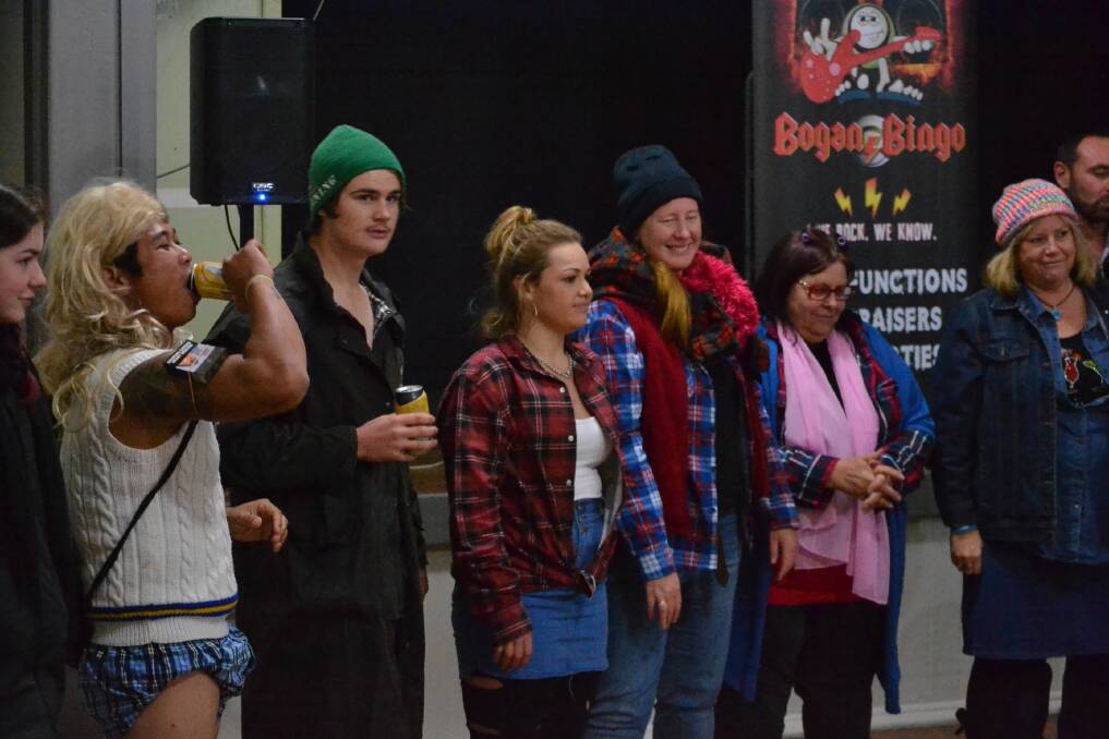 Down in front: the finalists for a lively game of 'Knobs and Knockers', a bogan 'heads or tails' equivalent which was played on Saturday night. 