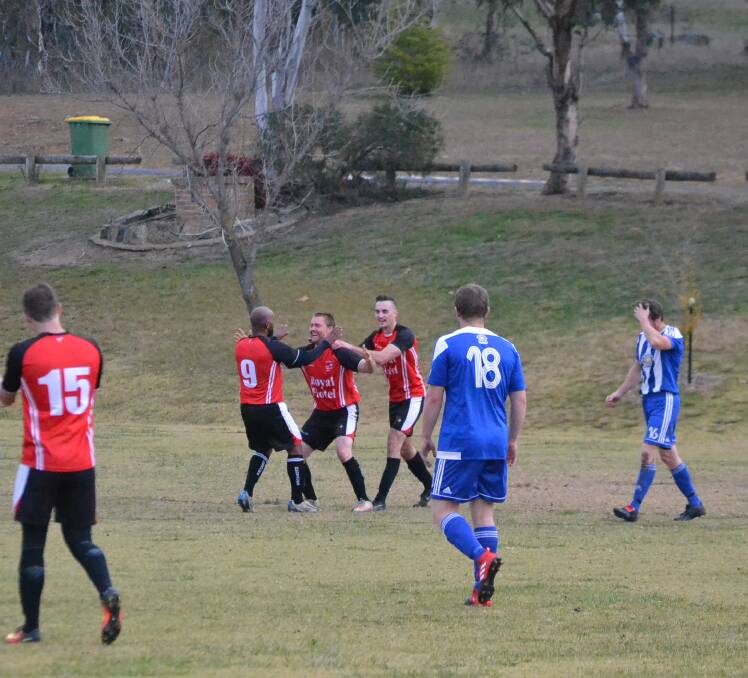 CLOSE WIN: Redbacks players celebrate the first goal of the match, which was soon followed by one more and proved too much for the Bullocks to chase. Photo: Zac Lowe. 