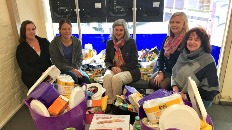 Sophie Curlewis and Loren Blundell of Yass Valley Property with members of 'Circle of Friends' and donated hampers for area families in hardship. Photo: Toby Vue