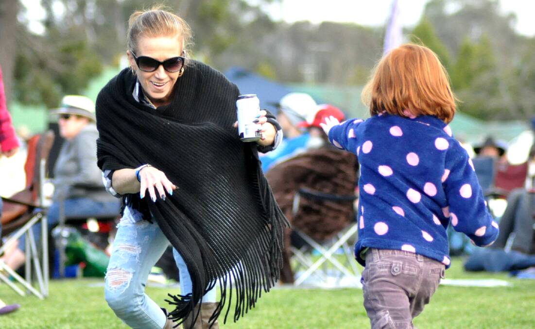 PICK OF THE PICS: Renee Simkus gets down and boogies with a little friend at the Gundaroo Music Festival on Saturday. Photo: Jessica Cole.
