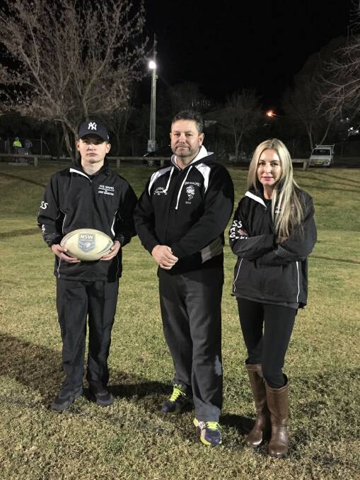 FIRST STEP: The sponsored merchandise (worn by Cian Jnr and Jane Ebert either side of coach Tony Vitler) have helped launch the Wayne Gouge cause.