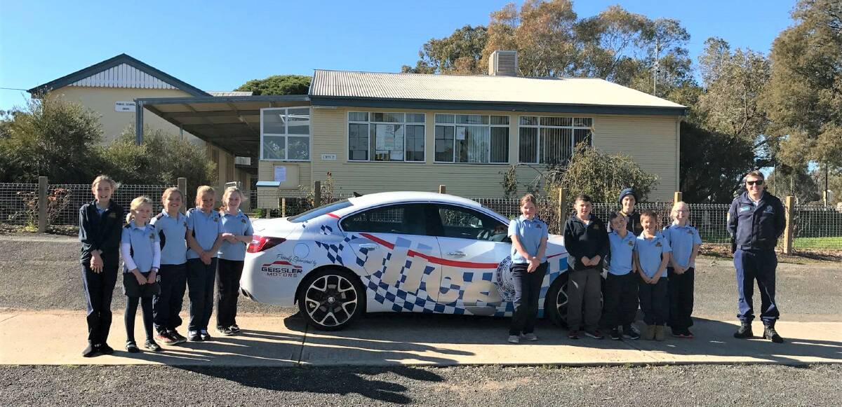 Yass Valley Police with the new vehicle and Binalong Public School students. Photo: Hume LAC