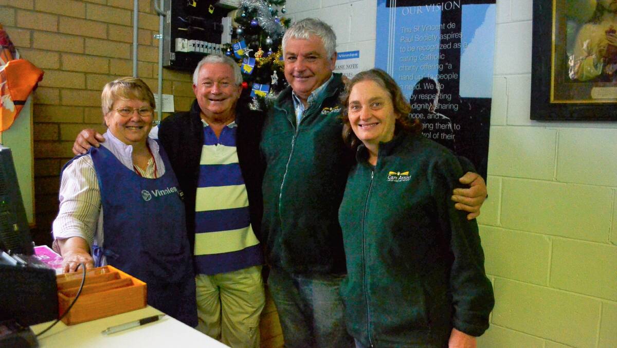 Christmas help: Len McGuigan (second from left) from Men's Shed donates to Therese Yates, Geoff Frost and Jean Frost. Photo: Toby Vue