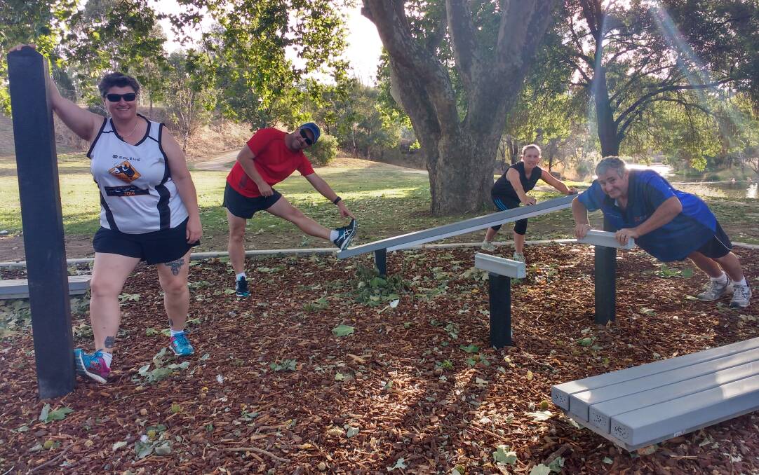 SET TO BOOST CARDIO: The Yass Runners and Walkers Club warm up at a fitness station before another Monday session. The club has announced a Saturday session that aims to increase membership numbers to host additional events. Photo: Toby Vue.