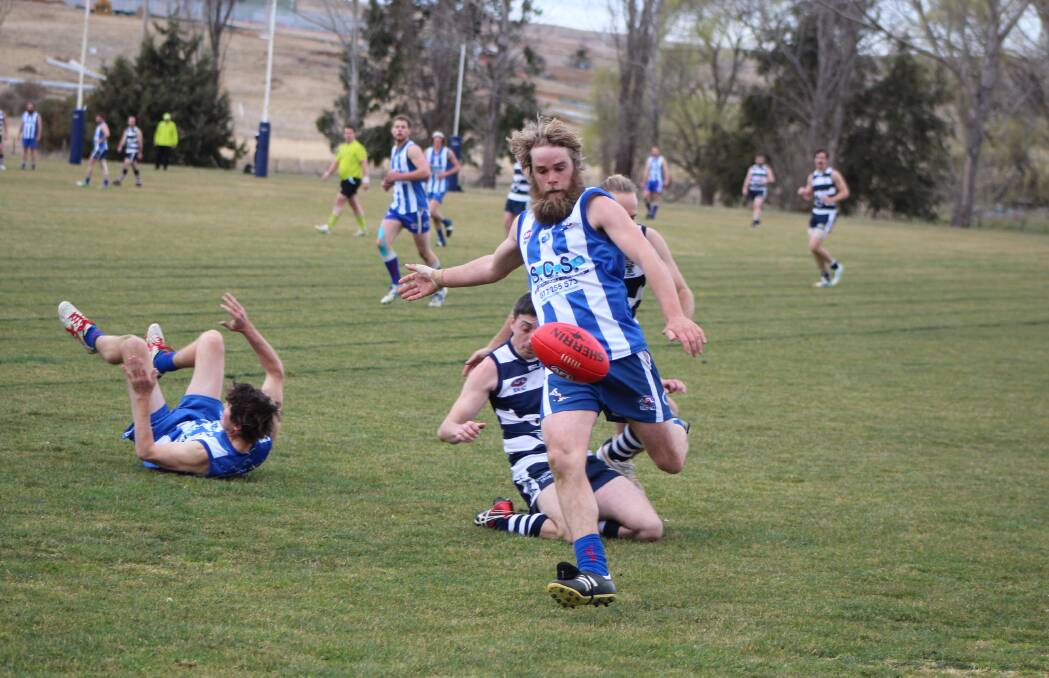 Kicking on: Roos player Matt Bosustow sending the ball forward against Cooma Cats, hoping to bring the same form on Saturday. Photo: Yass Tribune.