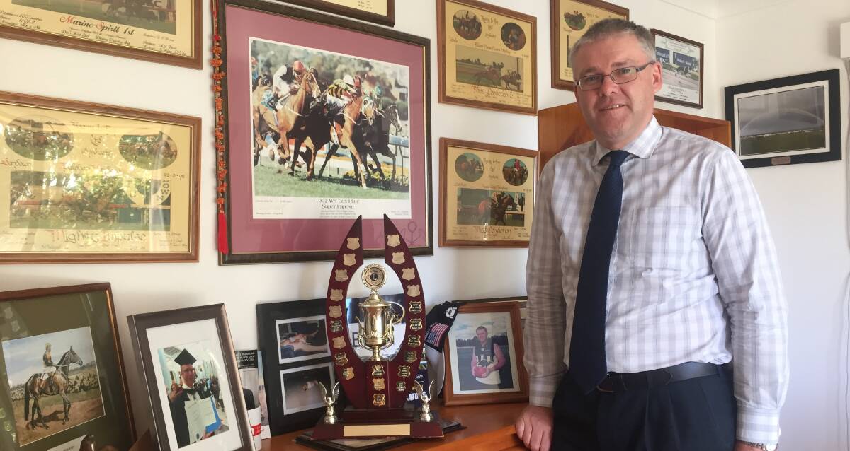 Voice of change: David O'Brien, vice president of the Yass Valley Sports Council, at his home with the 2015 trophy for team of the year and other memorabilia. Photo: Toby Vue