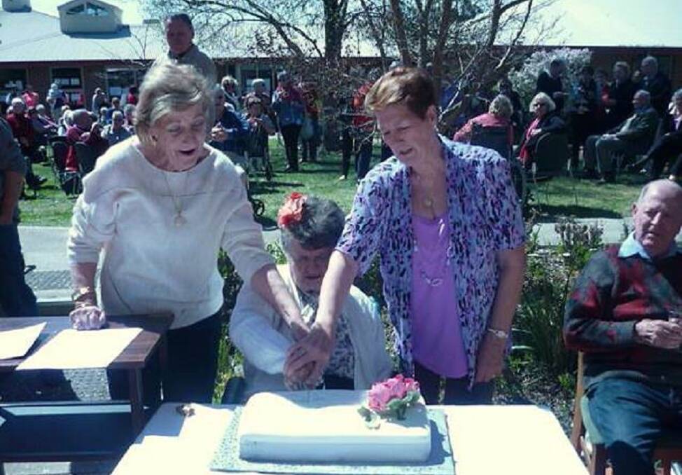 CAKE CUTTING: Barb Connor RN (left) and Janice Puckett RAO with 25 years of continual service and Nora Murphy (a resident since 2001). The gorgeous cake was generously made by Marg Mackay from The Friends of Horton House and Warmington Lodge. Photo: Supplied