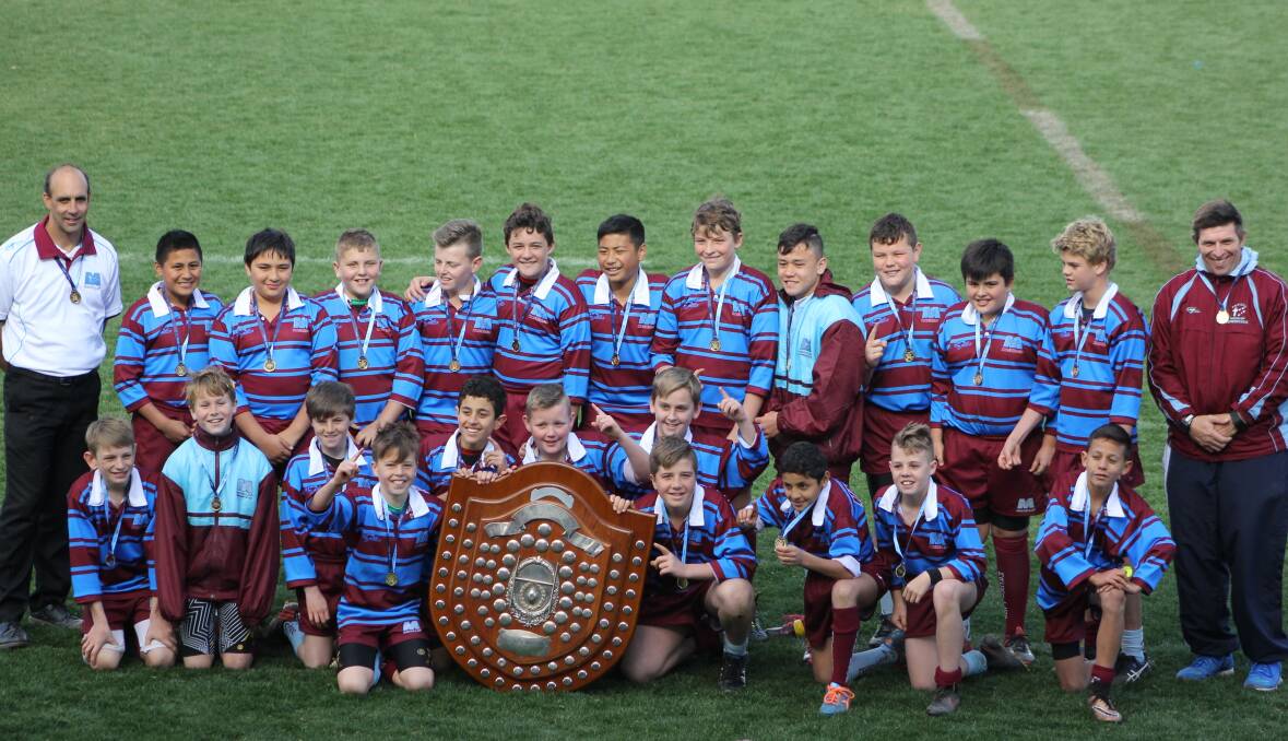 Perfect record: MacKillop NSW Catholic Primary School Sports Council (NSWCPS) show off their shield and medals from wining all their games in the NSW PSSA Rugby Union Championship. Photo: Sherree Bush.