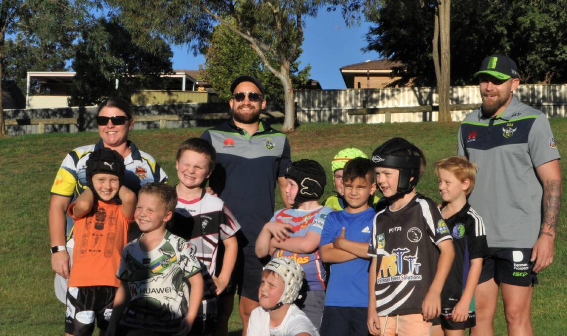HELPING JUNIORS: Canberra Raiders' Kurt Baptiste (centre) and Blake Austin (right) train with the Yass Magpies under 8s along with coach Naomi Jamieson (left) at Walker Park on March 28. Photo: Toby Vue