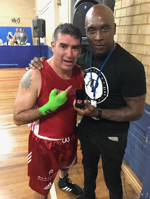 VICTORY SECURED: Spider presented with a King of the Ring title ring by Nigle Benn. Photo: Supplied