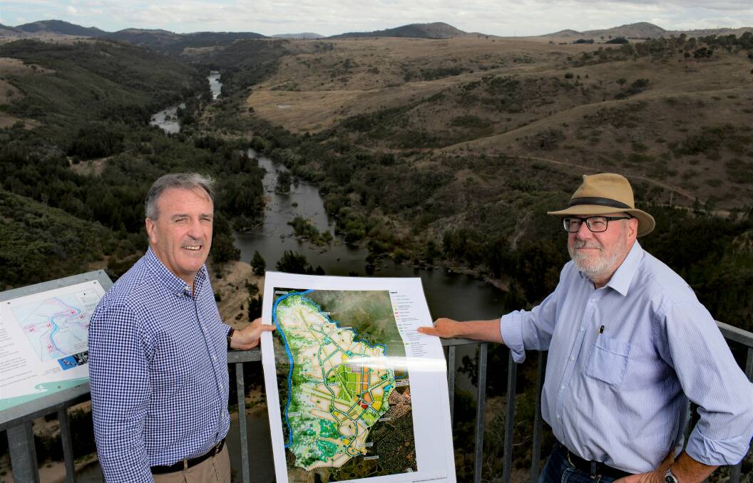 EXEMPT: The Parkwood planning proposal is exempt from the 5km transition zone. Pictured are Riverview Developments' director David Maxwell and planning consultant Tony Adam at Shepherds Lookout, overlooking the Murrumbidgee River. Photo: Sitthixay Ditthavong