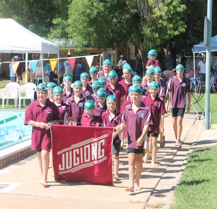 CHAMPIONS: The Jugiong Swimming Club edged out Harden to take the 51st Shine Shield competition. Pictured are members marching in matching club shirts and 'Play like Lui' caps. Photo: Jennette Lees