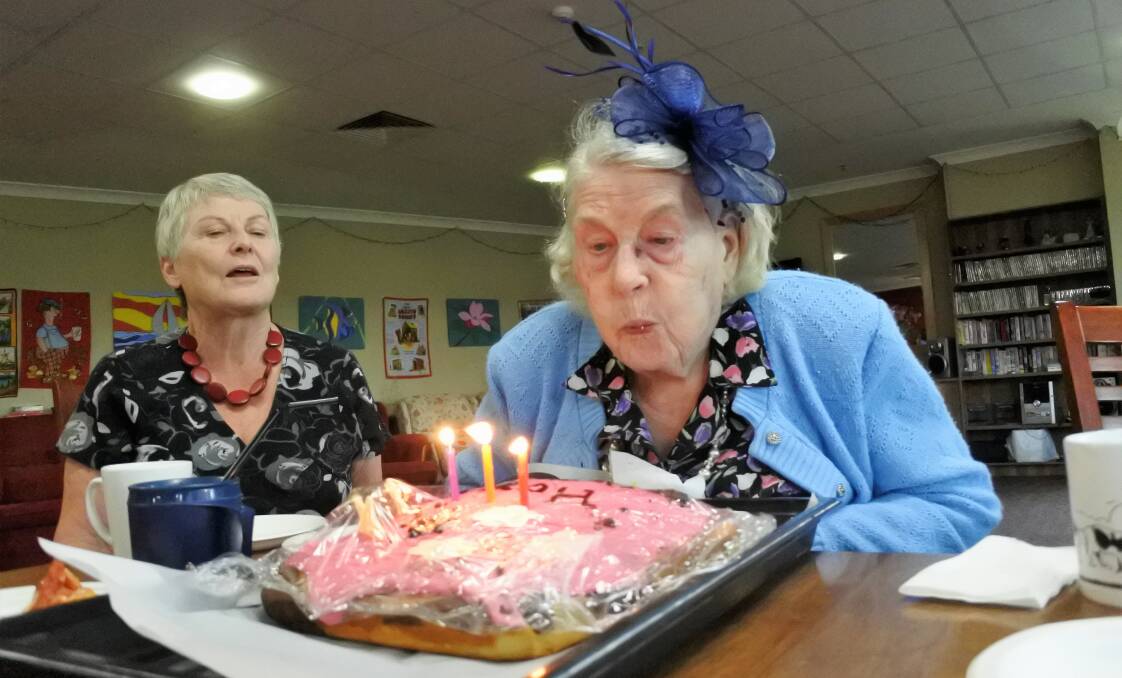 GOING STRONG: Hope Styles blows out the candles to celebrate her 103rd birthday while her daughter Judy Sime watches on. Photo: Toby Vue