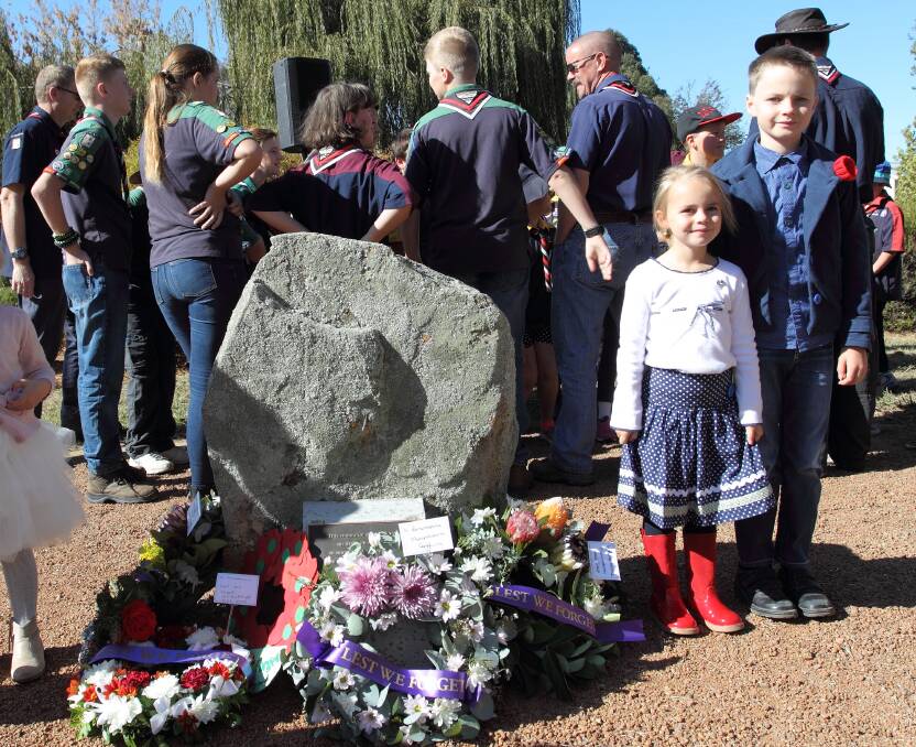 REMEMBERING THE FALLEN: A couple of children lay a wreath among others during the Murrumbateman Anzac Day services in 2016. Photo: RS Williams