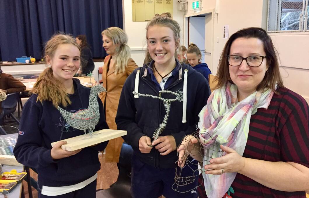 CREATIVITY DISPLAYED: Yass High School art teacher Amanda Moss and students with some of their sculptures from the workshops as part of Sculpture of the Paddock. Photo: Toby Vue.