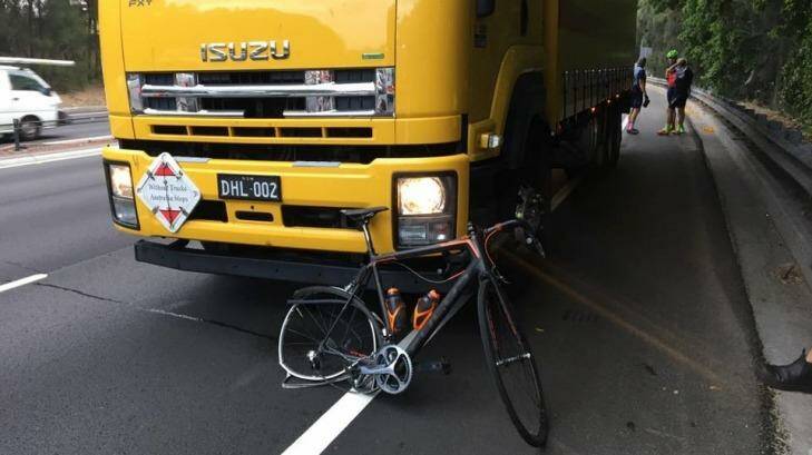 A damaged bike appeared to be wedged under the truck that hit the riders. Photo: Roberto Allen