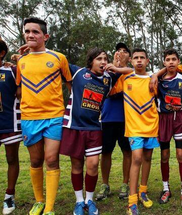 Congratulations: Players from Armidale and Moree unite following a match during the Clontarf Rugby League Festival. Photo: Lisa Maree Williams/Fairfax Media via Getty Images