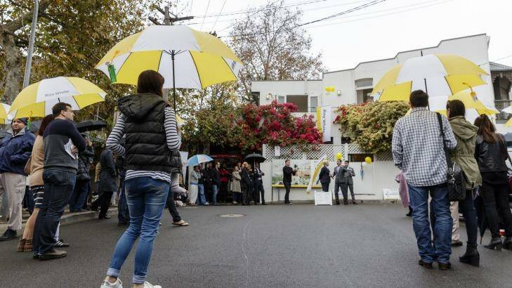 Crowds gather on a rainy morning for the auction of 17 Elfred Street in Paddington. Photo: Brook Mitchell
