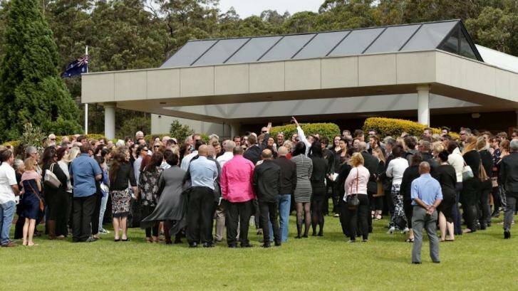 Mourners circled following the funeral service as butterflies were set free in tribute to Carly McBride.  Photo: Simone De Peak