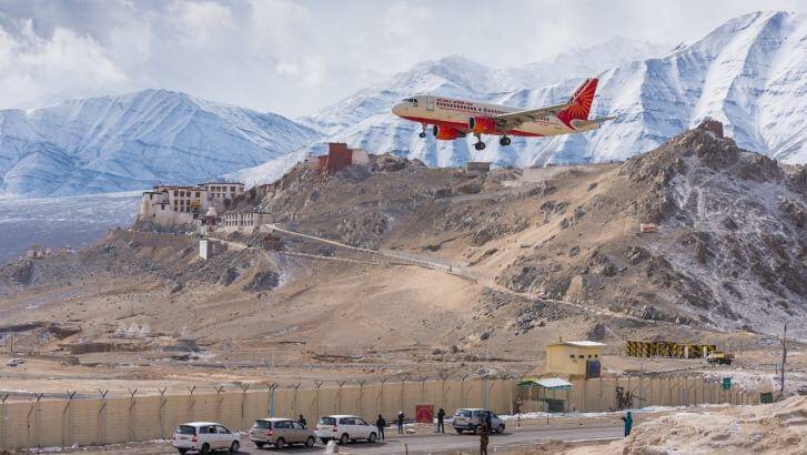 Air India plane landing passing monastery in Ladakh at Leh Airport, India.  Photo: tassapon