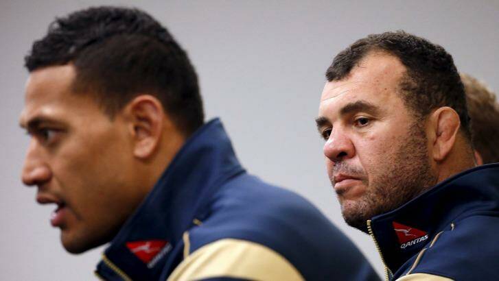 Coach Michael Cheika listens to Israel Folau speak at a media conference on Tuesday. Photo: David Gray