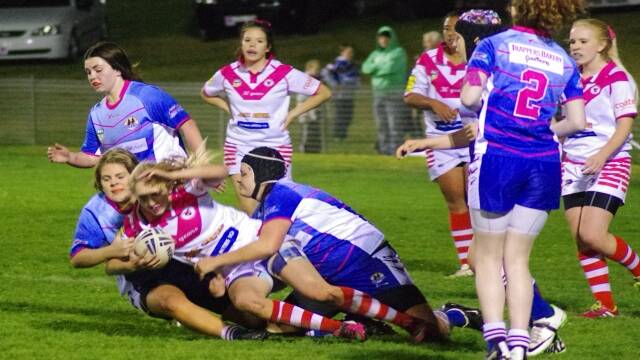 TEAMWORK: Goulburn U17 Stockmen girls Shanay Little and Tina Granger supported by Elle Thomas behind combine to bring down a Valley Dragons ball carrier during their clash at the Workers Arena on June 27.
