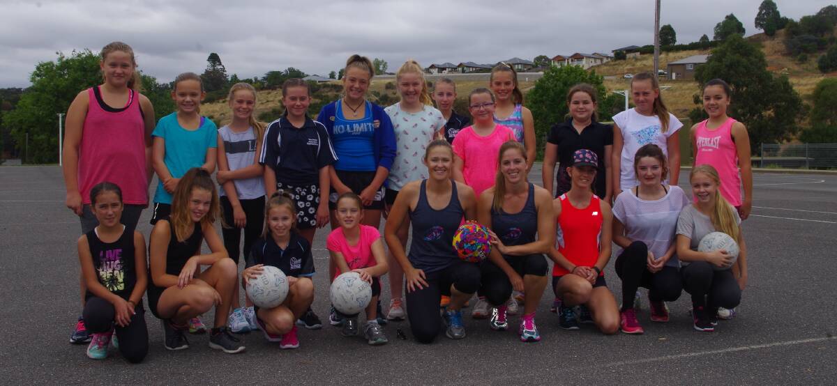 Sydney Swifts stars Susan Pratley (left) and Caitlyn Byrne (right) put the Yass representative netball team through its paces. 