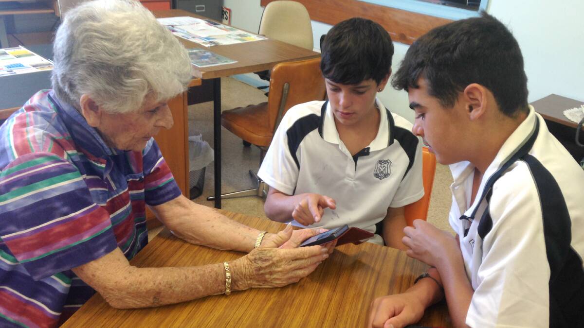 Students participate in the exercise which helped some of the Yass Valley senior citizens how to use their mobile phones effectively.