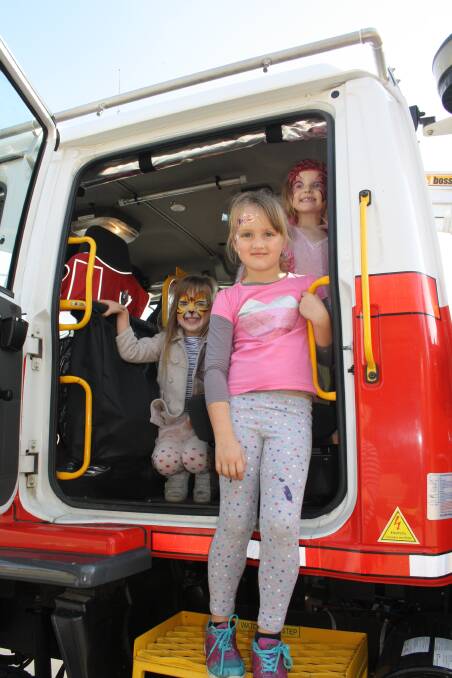 Abbi-Lee, Cherelle and Olivia Pascoe took a ride in the fire engine at the Yass Fire Station open day. Photo: Alix Douglas.