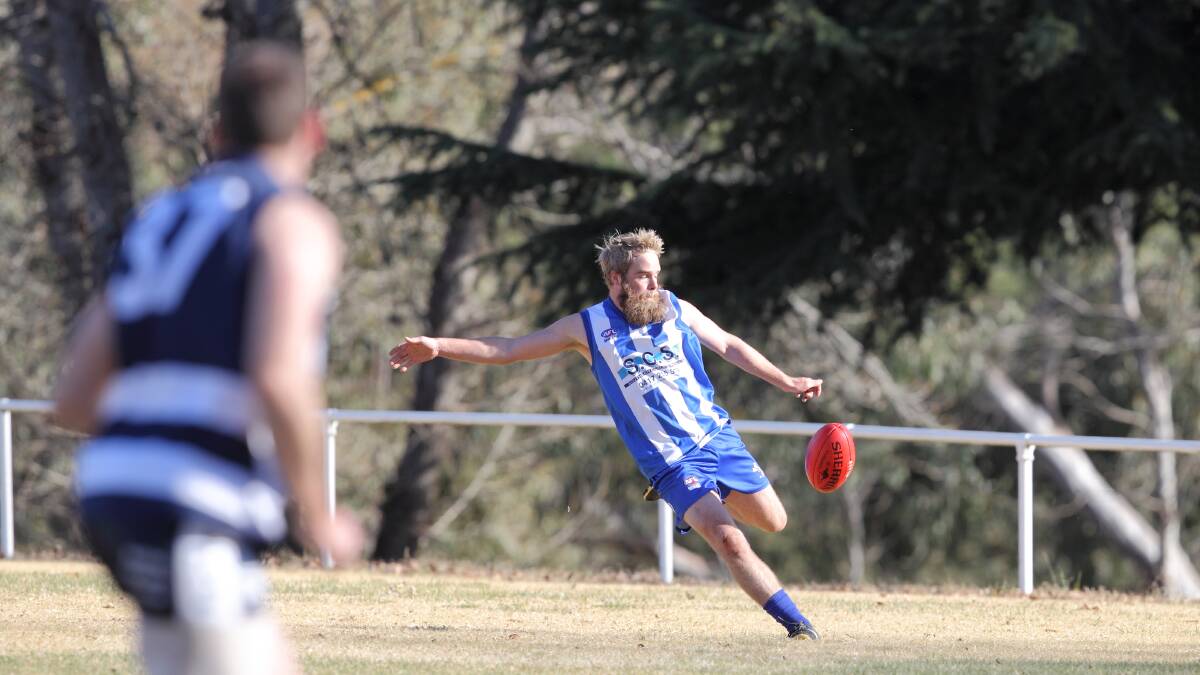 Matt Bosustow takes a kick for the Yass Roos. Photo: RS Williams.