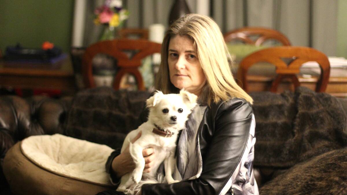 Nadine Handford with her surviving dog Kimba. Photo: Jessica Cole.  