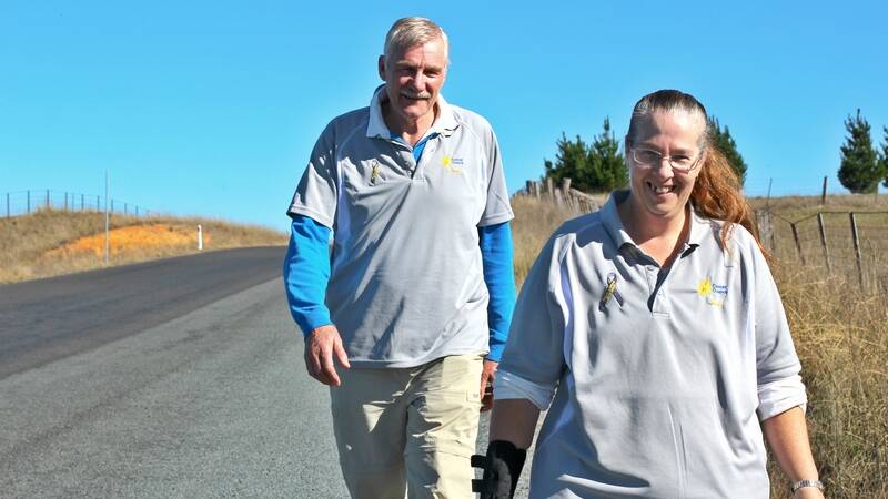 CAPTION: Stewart Pasfield and Ann-Marie Randell having already tackled 230km in their long journey to Canberra. They set out on Dog Trap Road in Yass on Monday to raise funds for the Cancer Council. Photo: Jessica Cole.