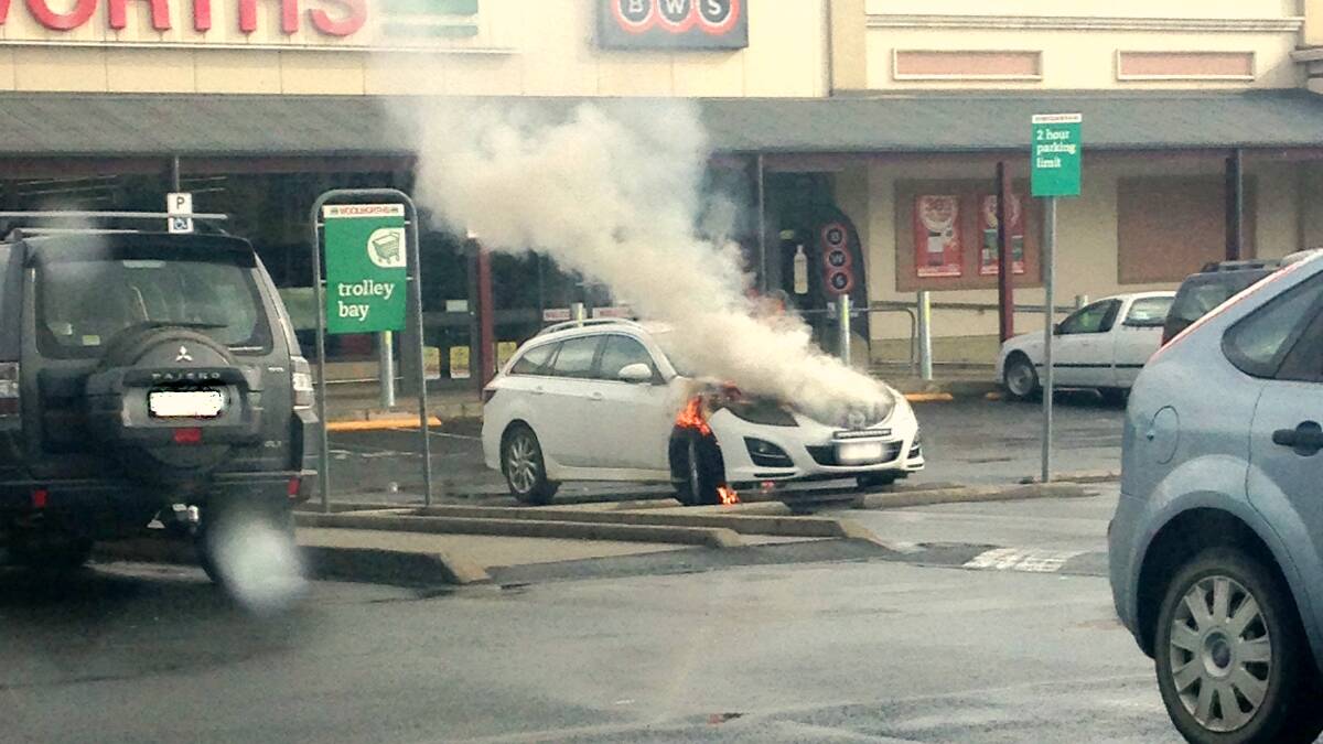 A car ablaze at Yass Woolworths on Wednesday afternoon. Photo: Nam Collins. 