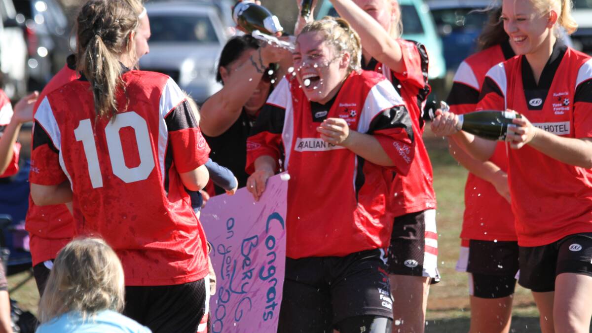 Bek Gallagher celebrates her 200th game at the weekend while friends and teammates showered her with champagne in celebration after their win. Photo: Jodie Gallagher. 