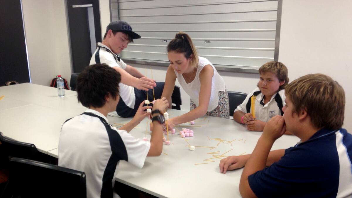 Students working together to create their tower of marshmallows and dry spaghetti. Photos: Susan Fagan.