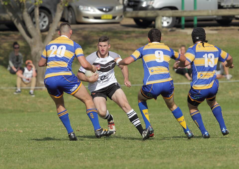 TRAFFIC: John Hall takes on the Woden Rams defence. Photo: RS Williams. 