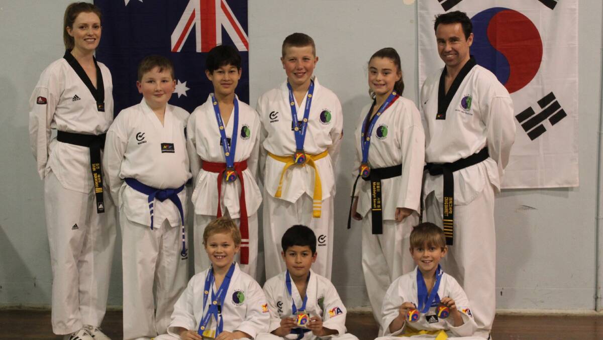 The Yass Sipjin Taekwondo team headed by Master Craig Barrett (right) and Vivienne Barrett (left) won a number of medals at the recent ACT Championships. Photo: Supplied.