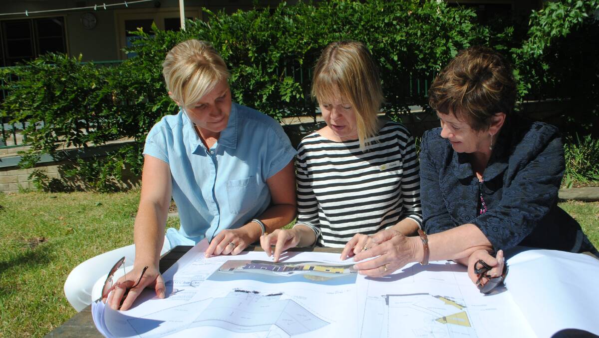 Secretary of the YECCA board Sally Butt, Director Fiona Nolan and Labor Candidate for Goulburn Ursula Stephens go over the plans for YECCA's revamp. Photo: Oliver Watson.