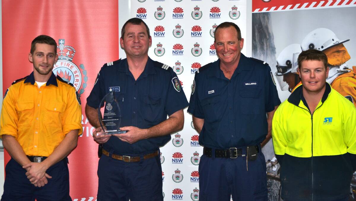 Shepherd Electrical employees and Wallaroo Fire Brigade volunteers Aaron Vincent, Neil Shepherd, Shane Allan and Brody Hunter received an award from the NSW Rural Fire Service on Wednesday. Photo: Oliver Watson.