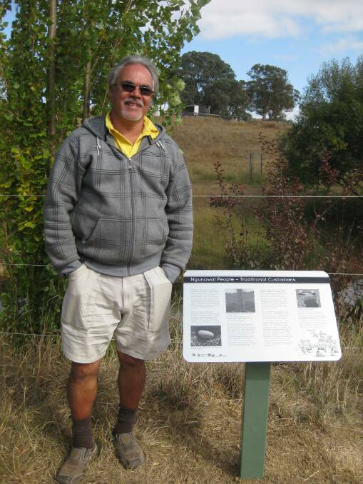 Ngunnawal custodian/elder Wally Bell with the interpretative sign about the site's connection to Aboriginal history in the newly opened Bruce Bray Riparian Walk in Gunning.
