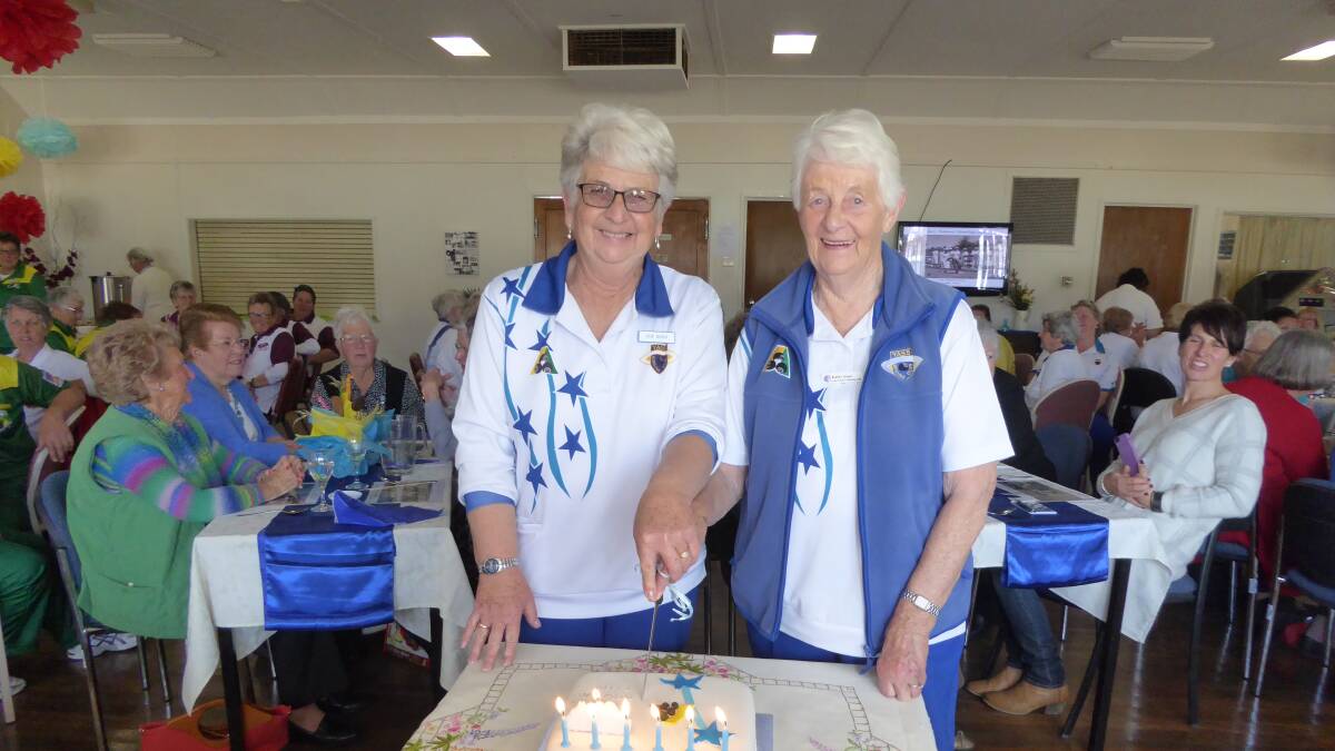Vice Presidents Sue Bush and Kath Grace cutting the birthday cake on Saturday. The cake was made by Wilma Bingley. Photos: Supplied.

