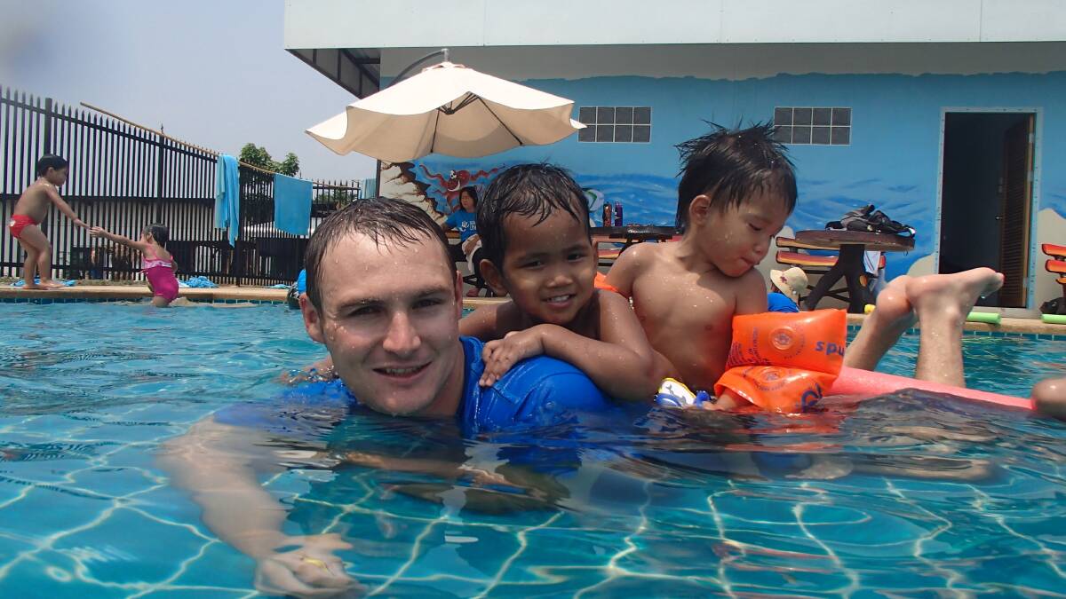 Ben Spencer teaching the children of the HIV orphanage in Thailand basic skills in the water.   
