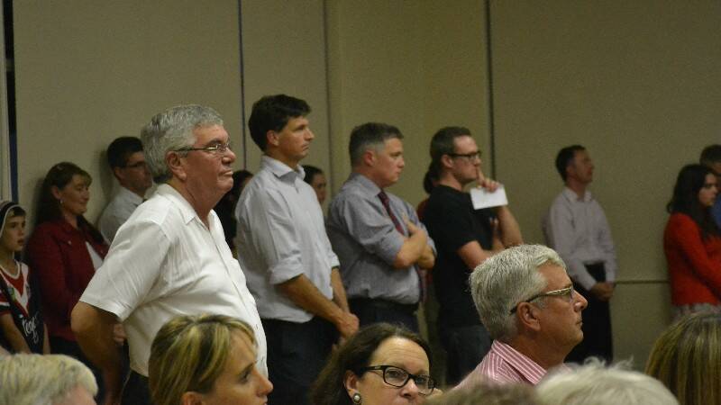 Parish priest, Father Mick Burke, standing left, next to Hume MP Angus Taylor.