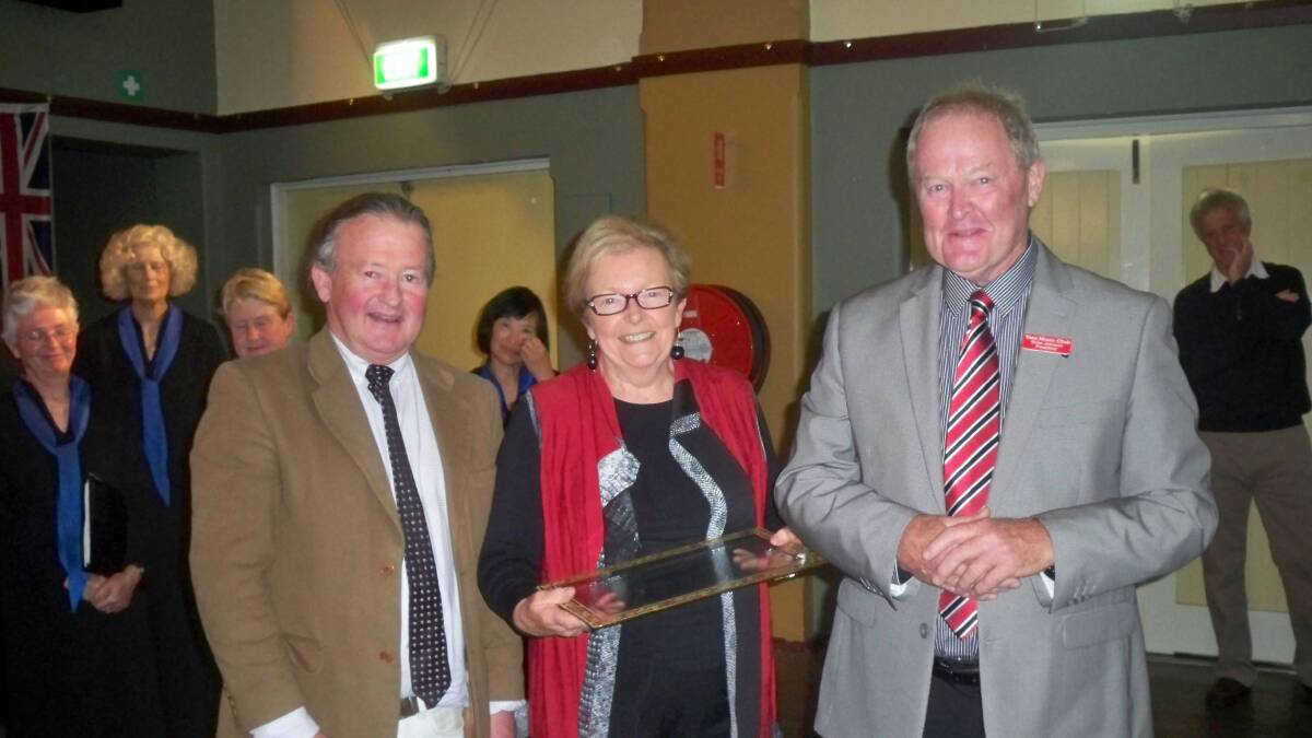 Peter Crisp presenting Nancy and Brian Johnson (outgoing president) with an award.

